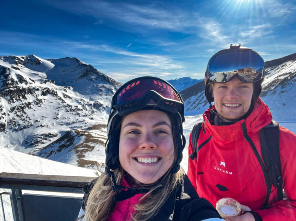 The author Amber Visch with a man, smiling at the top of Punta Bagna