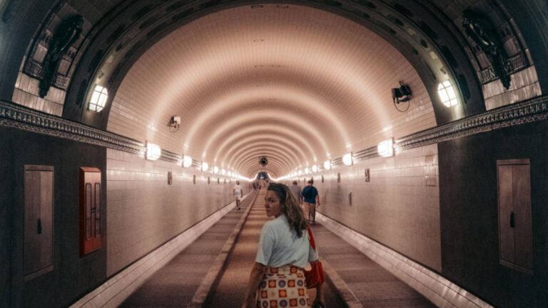 The author Amber Visch walking along in the iconic Elbtunnel