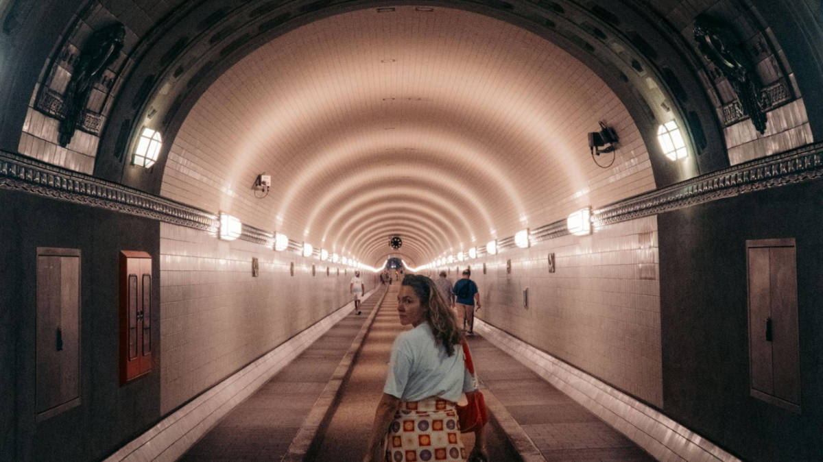 The author Amber Visch walking along in the iconic Elbtunnel