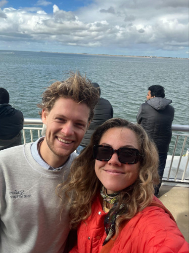 The author Amber Visch and her boyfriend, smiling for a photo while riding the ferry