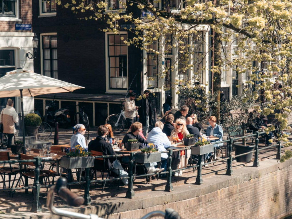 The Amsterdammers dining along the canal on a sunny day