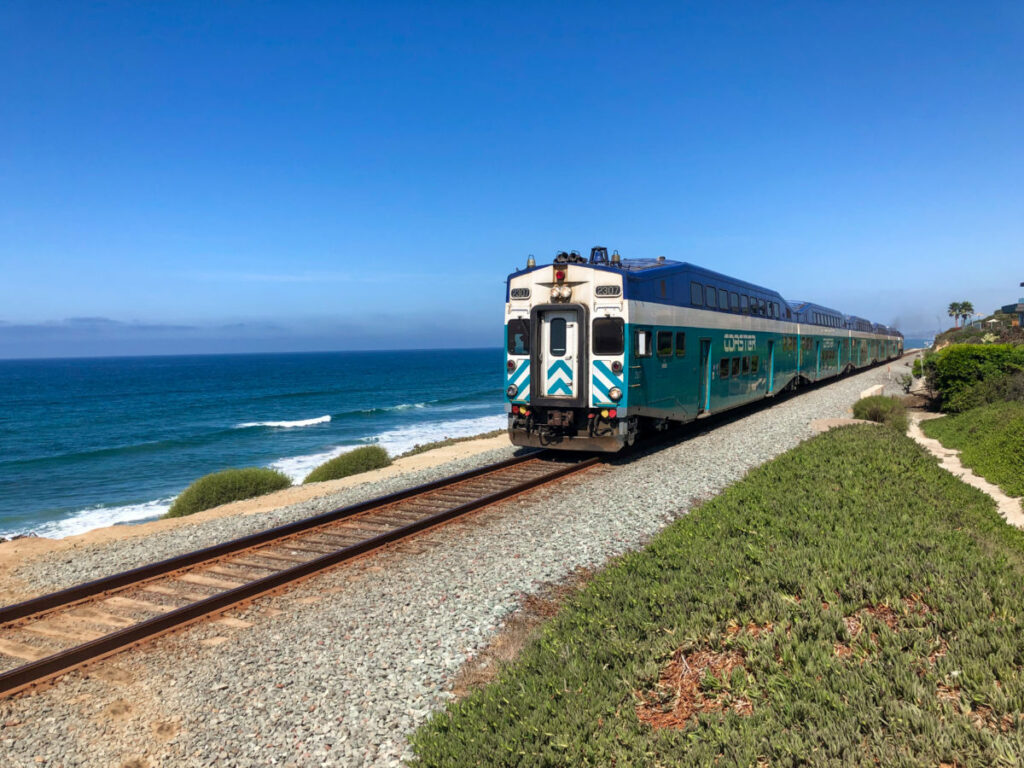 Amtrak Pacific Surfliner train near the blue ocean