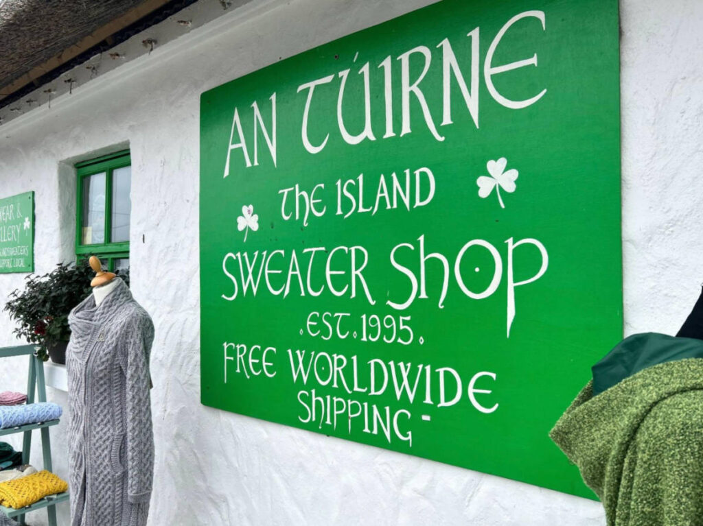 A bold green signage of An Túirne on the white wall