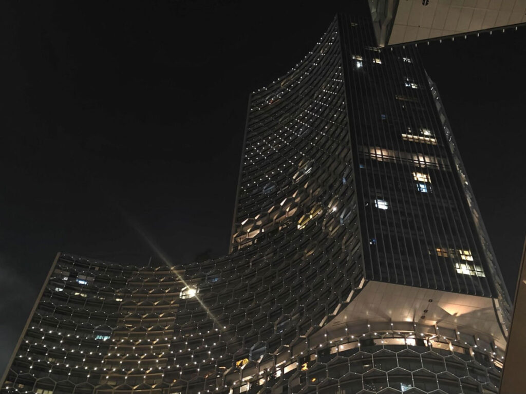 Facade of Andaz Singapore by Hyatt at night seen from below