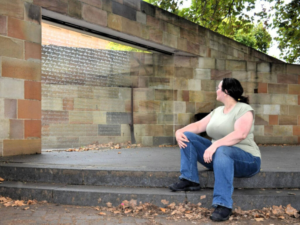 The author Ann-Marie Cahill, sitting at the Hyde Park Barracks