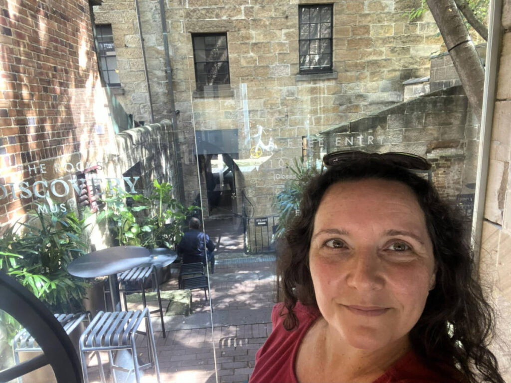 The author Ann-Marie Cahill, smiling for a photo outside the Rocks Discovery Museum