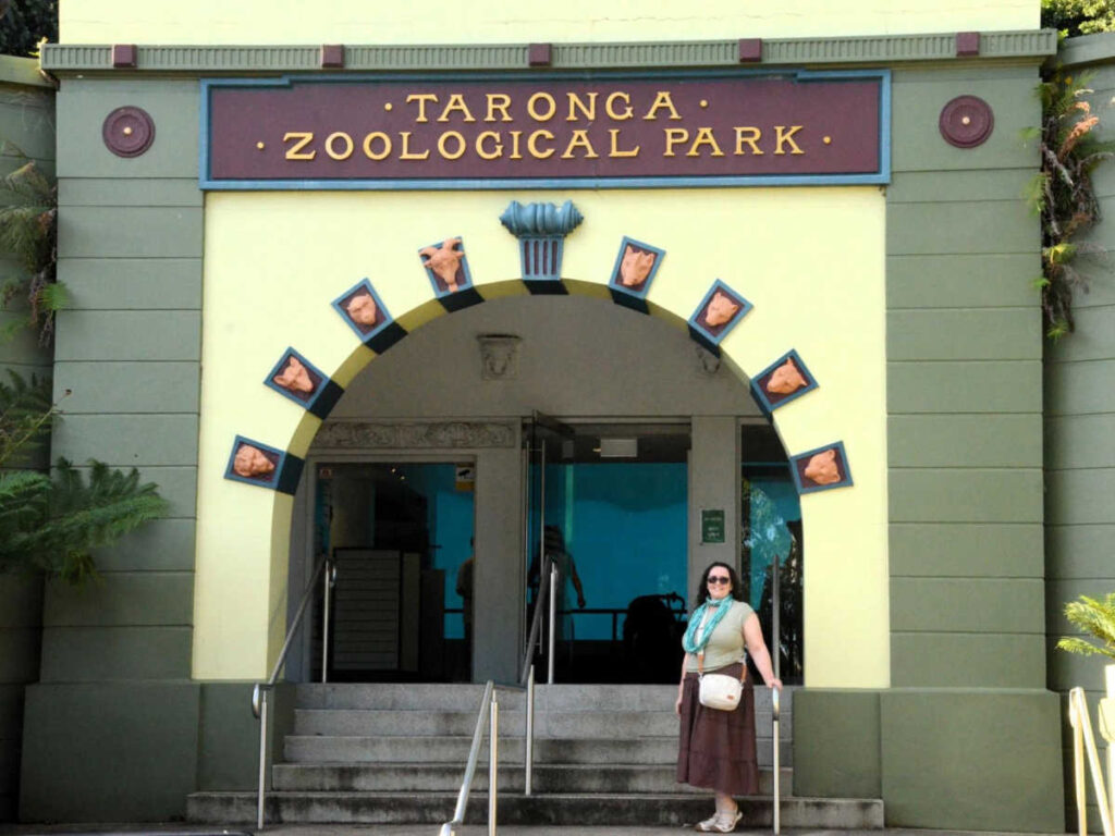 The author Ann-Marie Cahill, standing at the entrance of Taronga Zoo