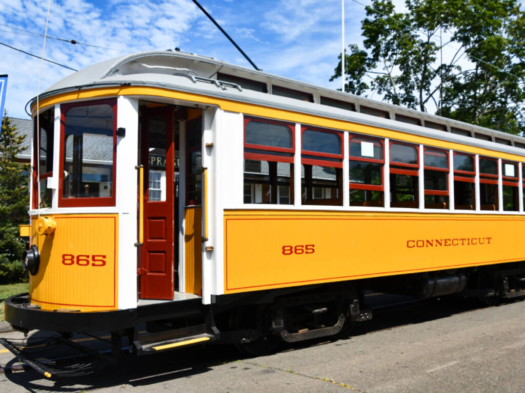 A bright yellow antique trolley at the Connecticut Trolley Museum