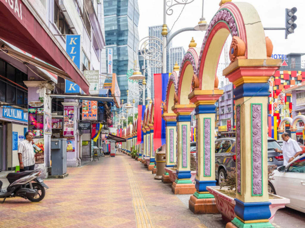View of the colorful ornate arches and shops along the busy street in Little India