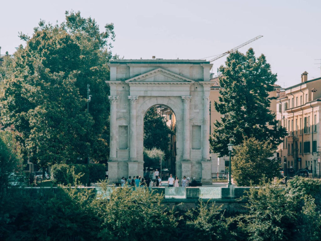 View of the Arco dei Gavi surrounded by greenery