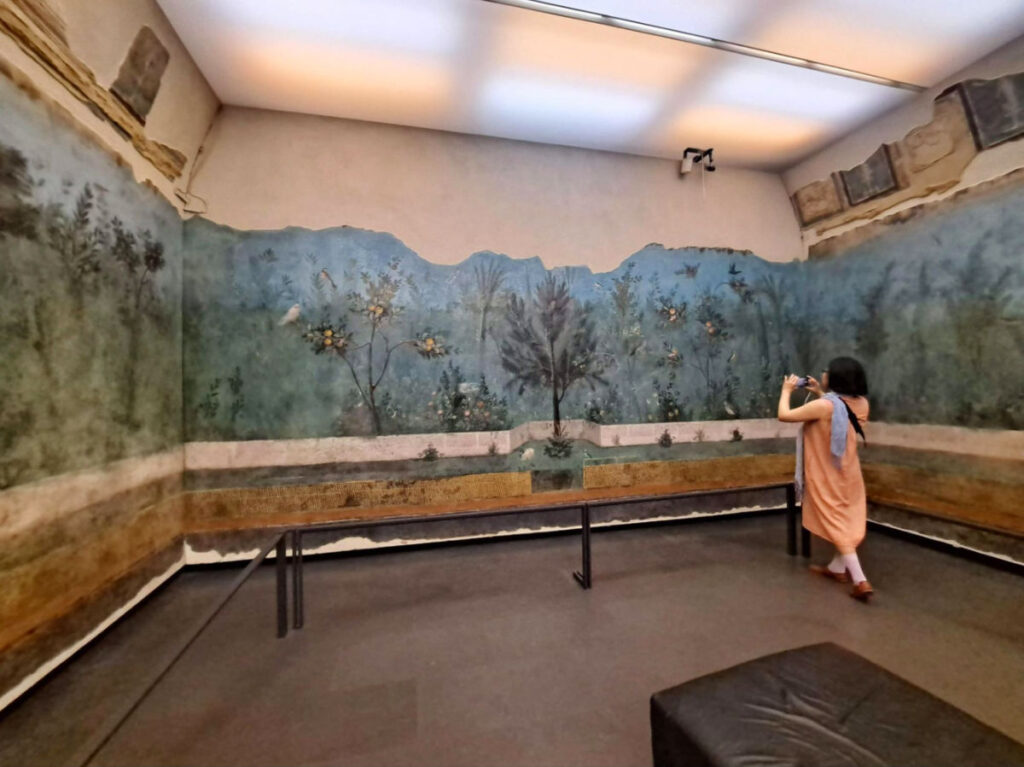A woman taking a picture of the reconstruction of an aristocrat’s villa at the Roman National Museum