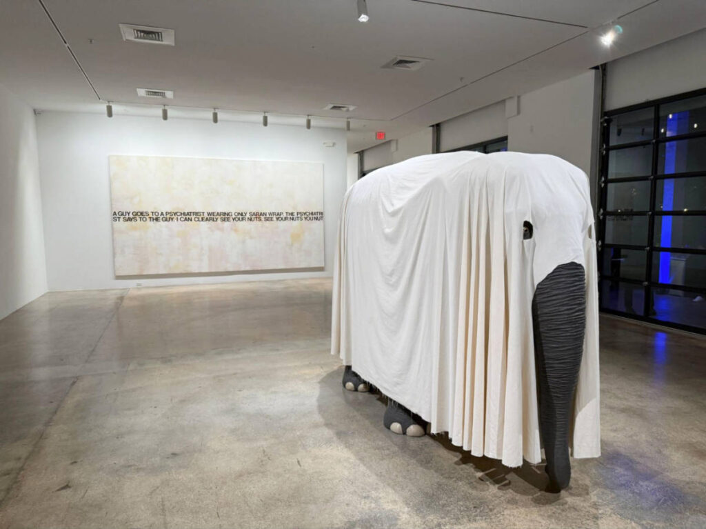 An elephant covered with white cloth displayed in an art exhibit in Rubell Museum