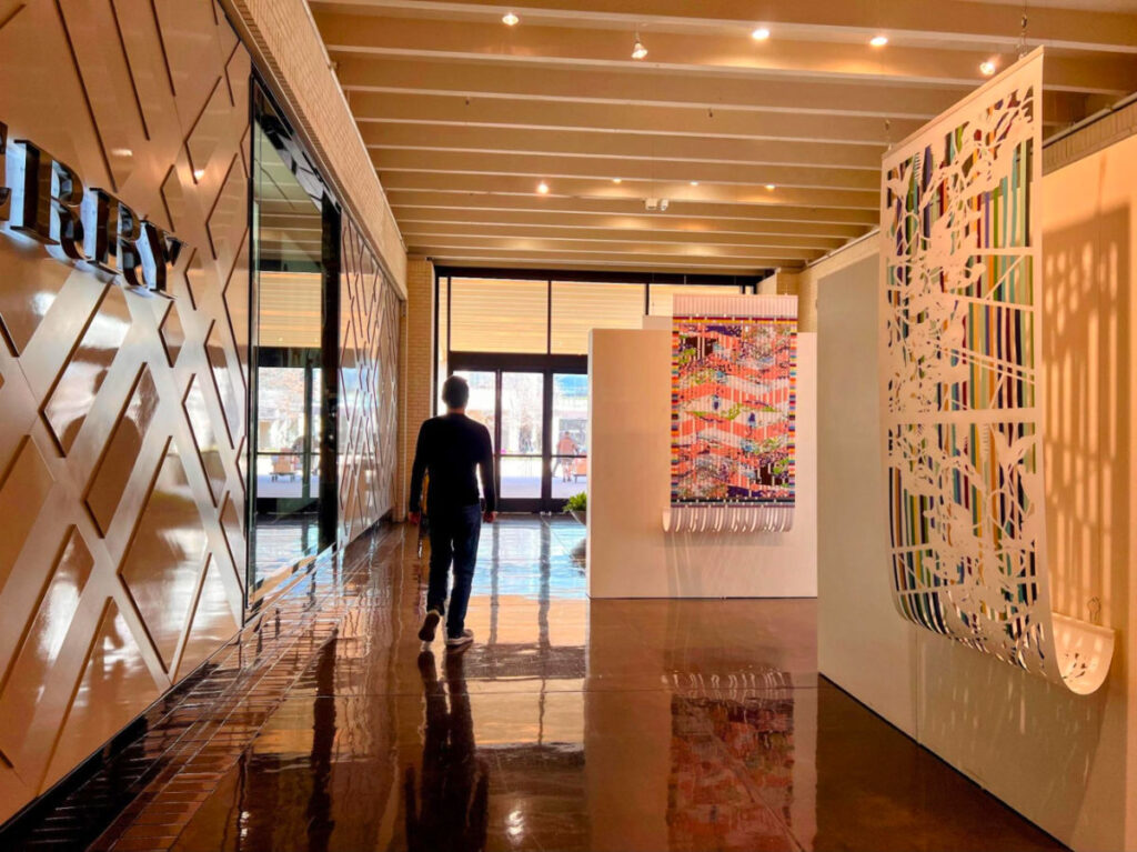 Author's husband admiring artwork at the Art Show in NorthPark Center Mall
