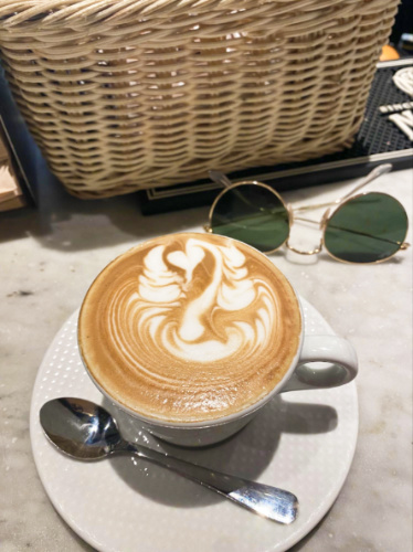 A glass of latte with an art
