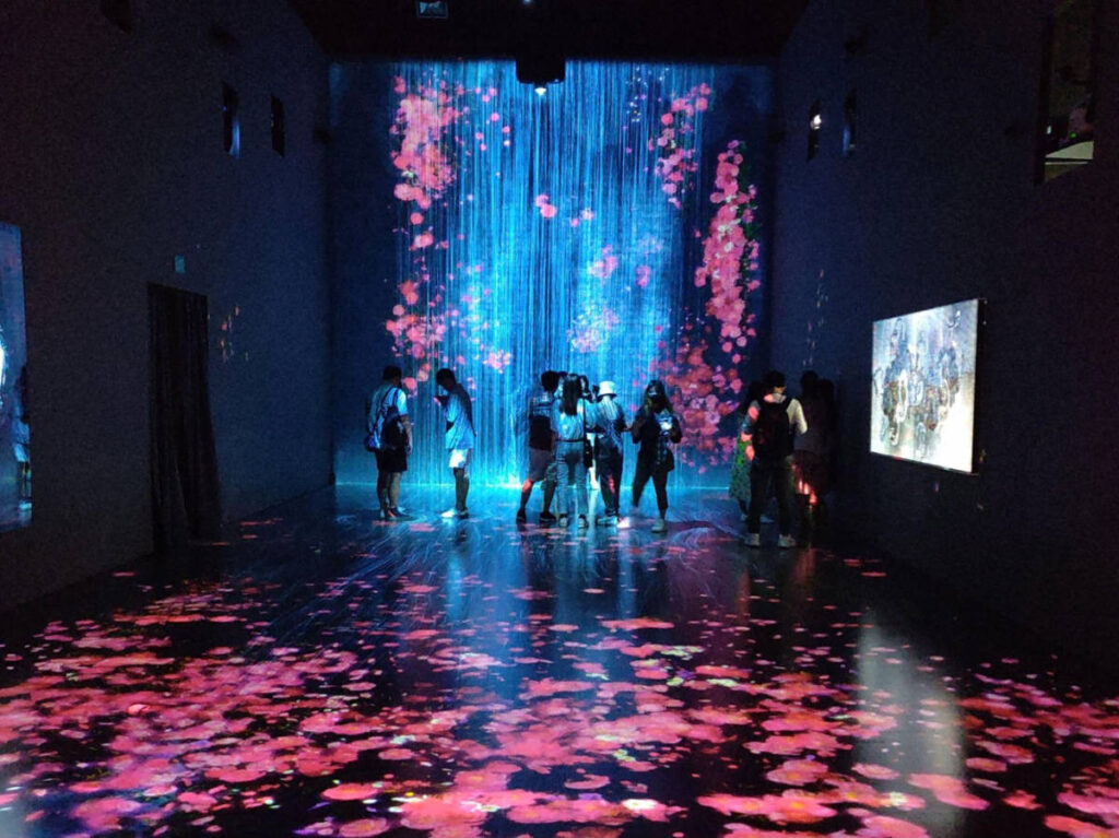 View of people admiring the exhibit inside the ArtScience Museum