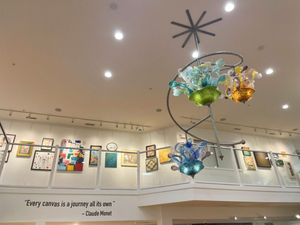 View of the colorful chandelier and the artworks in the Art League of Ocean City
