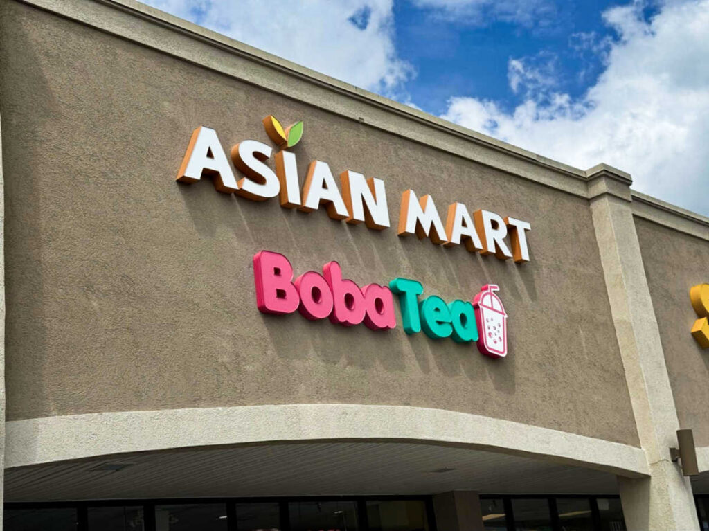 View of the signage of the Asian Mart Boba Tea in front of the building