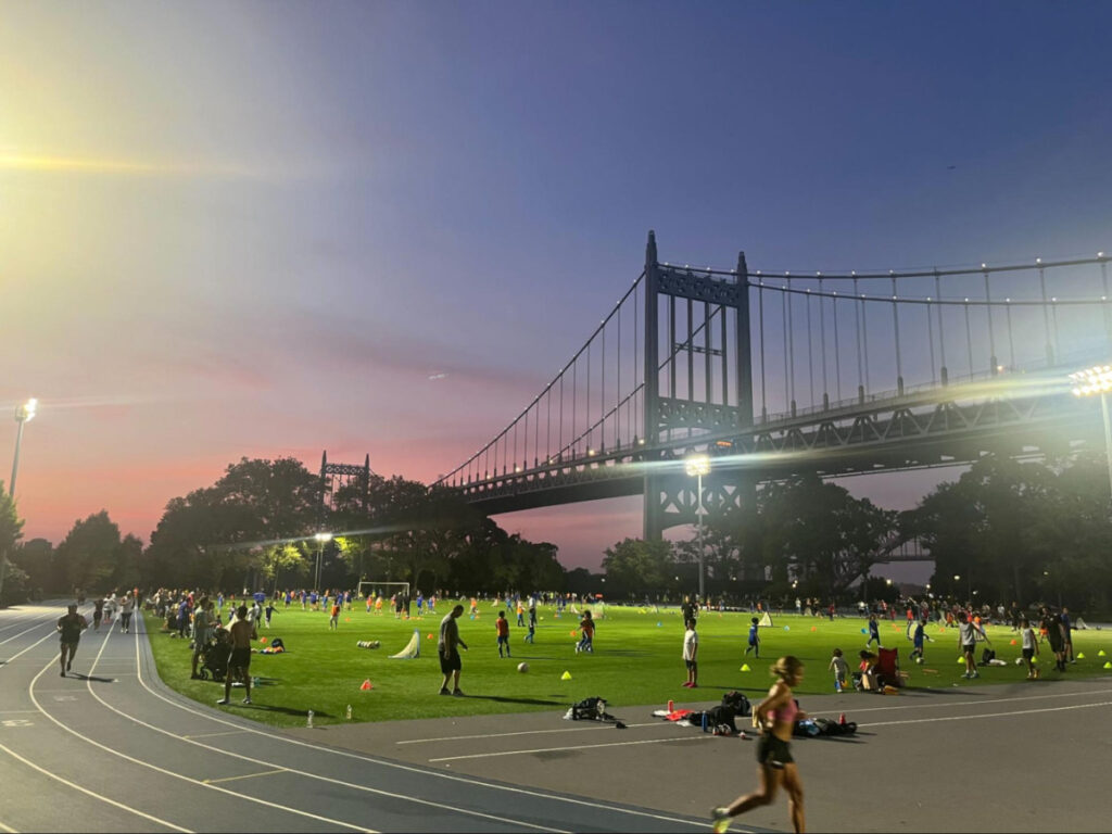 People doing all sorts of activities at The Astoria Park track during sunset