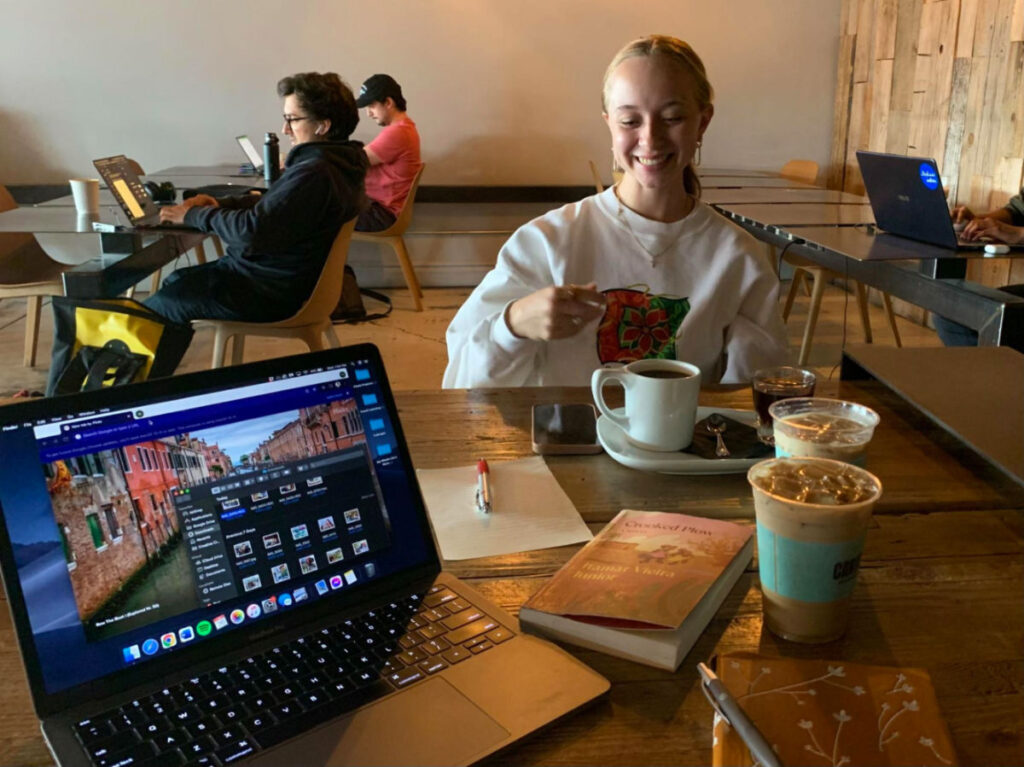 Author Betty and her friend enjoying coffee while working on their laptop