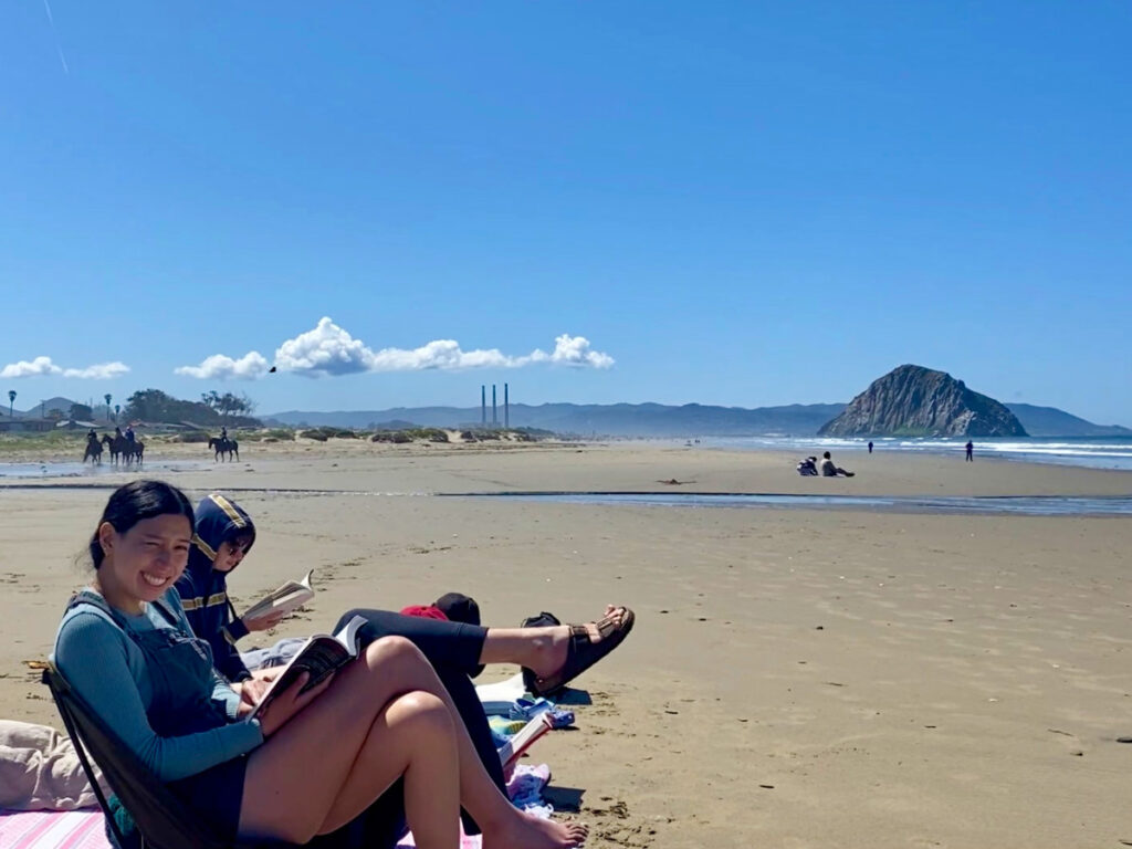Author Laura McFarland and friends reading books on Morro Strand State Beach