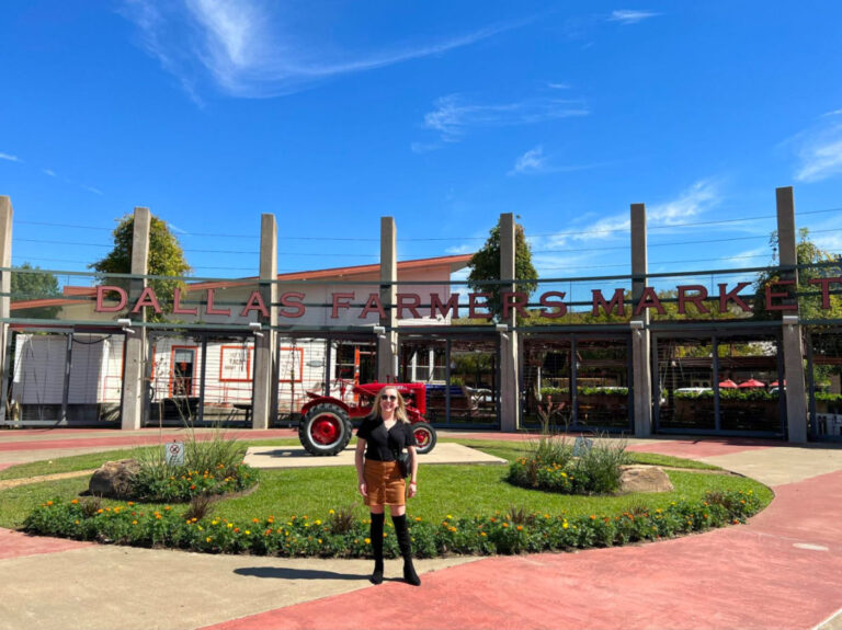 Author Sarah Heath in front of the Dallas Farmers Market Sign