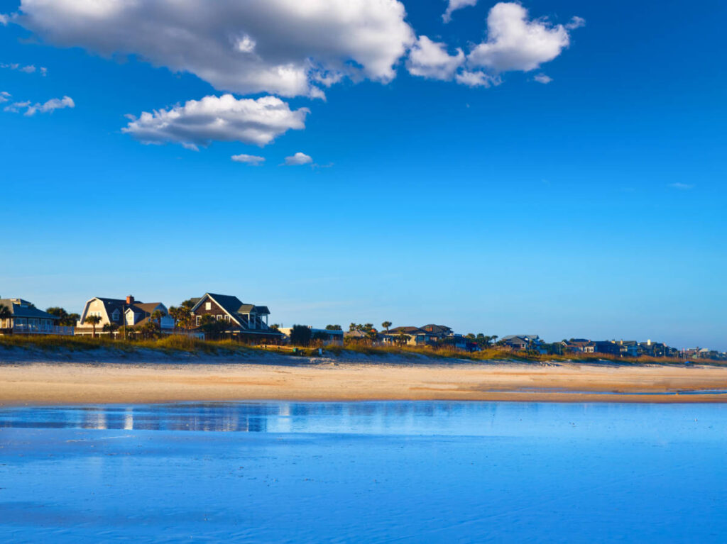 Panoramic view of the houses along the Atlantic Beach in the middle of the deep blue sky and ocean 