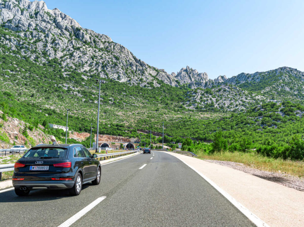 An Audi car driving along the suburban highway