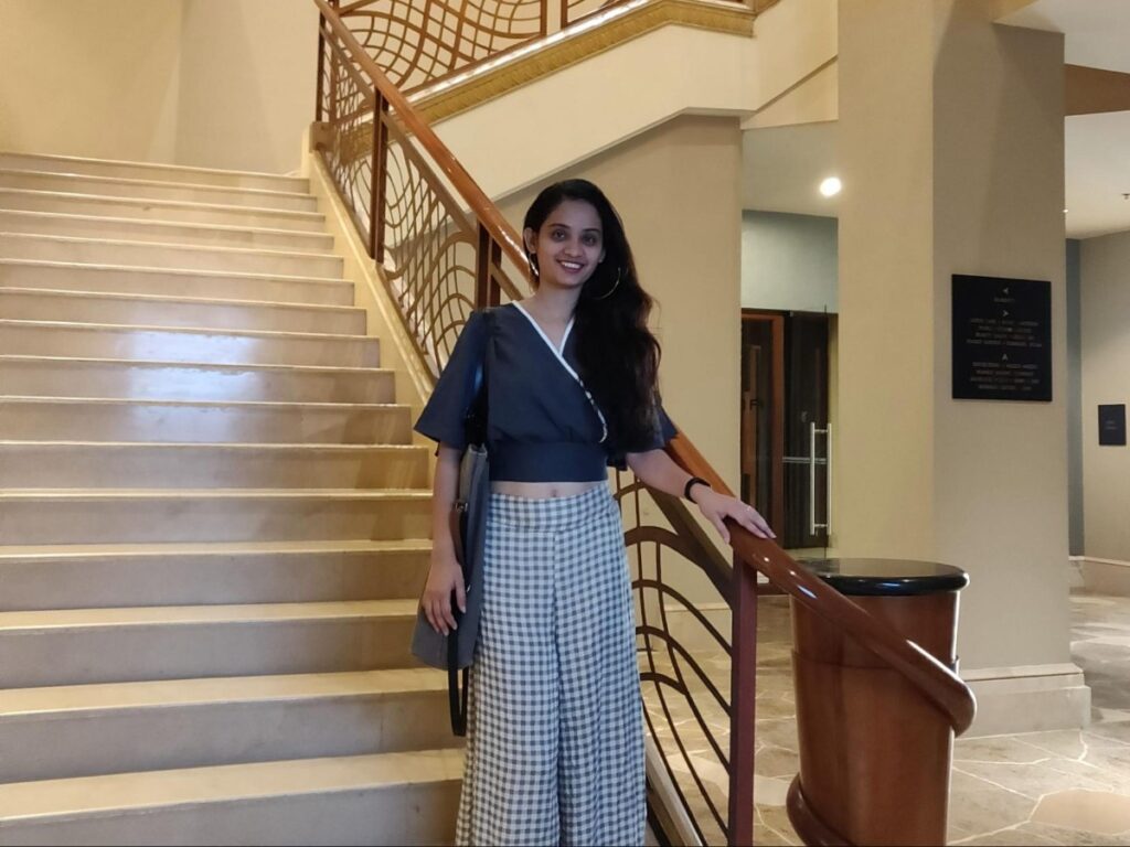 Author Advaita standing at the stairs of JW Marriott Hotel