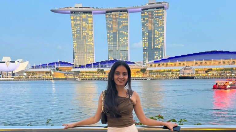 Author Advaita at the Fullerton Promenade with the Marina Bay Sands Hotel in the background