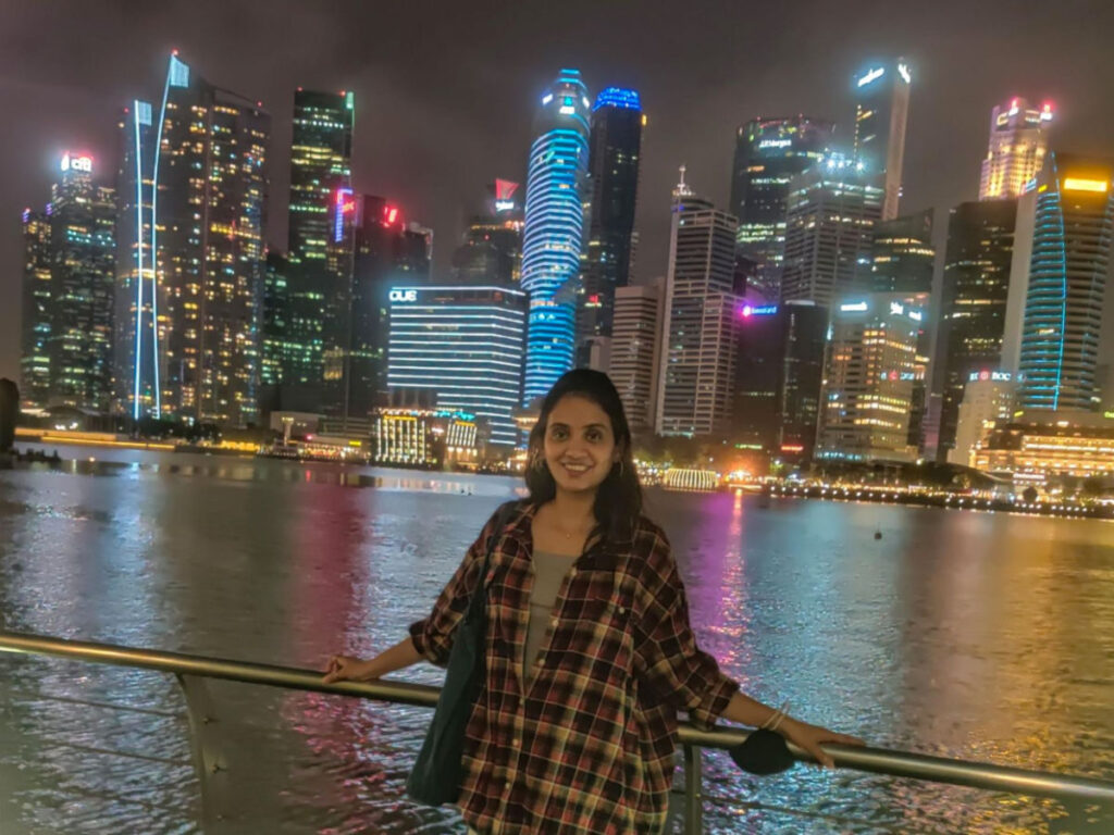 Author Advaita at the Marina Bay promenade with the Singapore skyline in the background