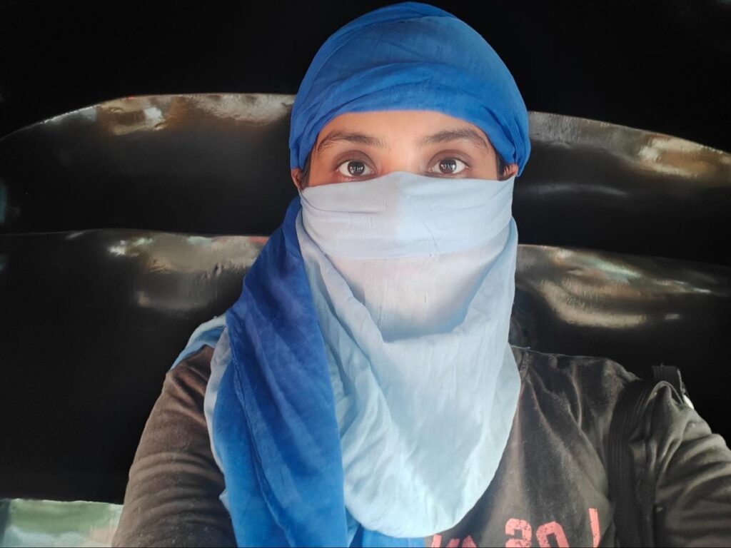 Author Advaita wearing a scarf while traveling in an auto-rickshaw