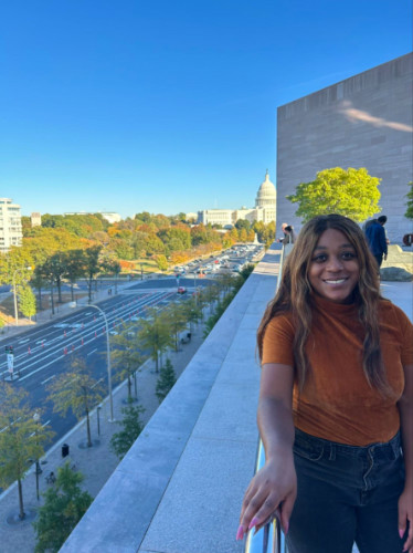 Author Alexandria standing on the rooftop of the National Gallery of Art in the fall