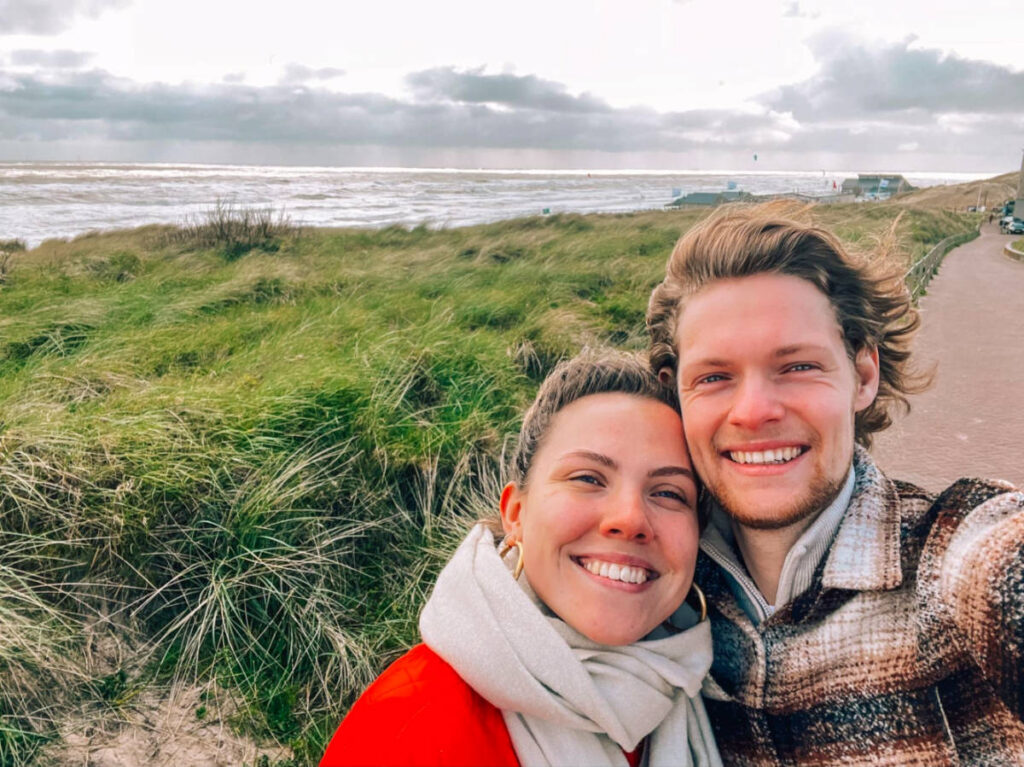 Author Amber and her boyfriend taking a selfie at the beach