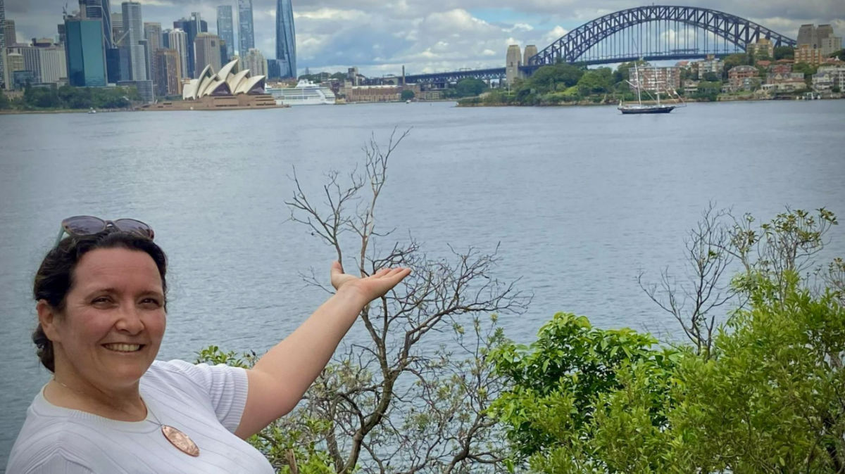 Author Ann-Marie poses for a photo with Sydney Harbour in the background