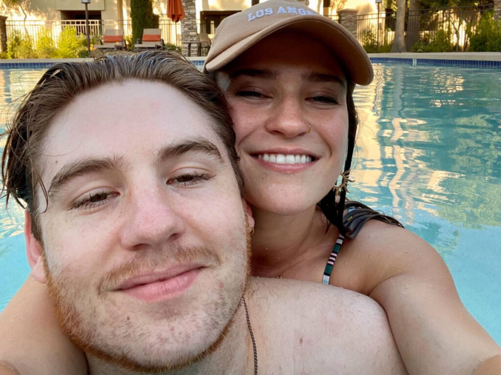 Author Betty and boyfriend enjoying their day on an apartment pool