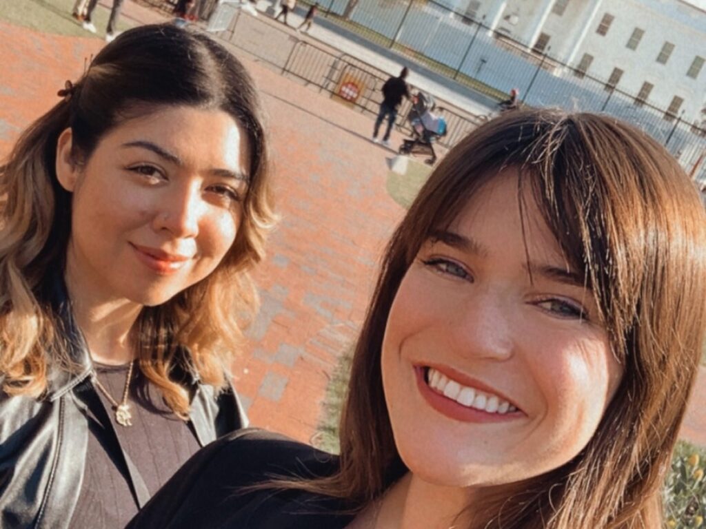 Author Betty and her coworker taking a selfie by the White House