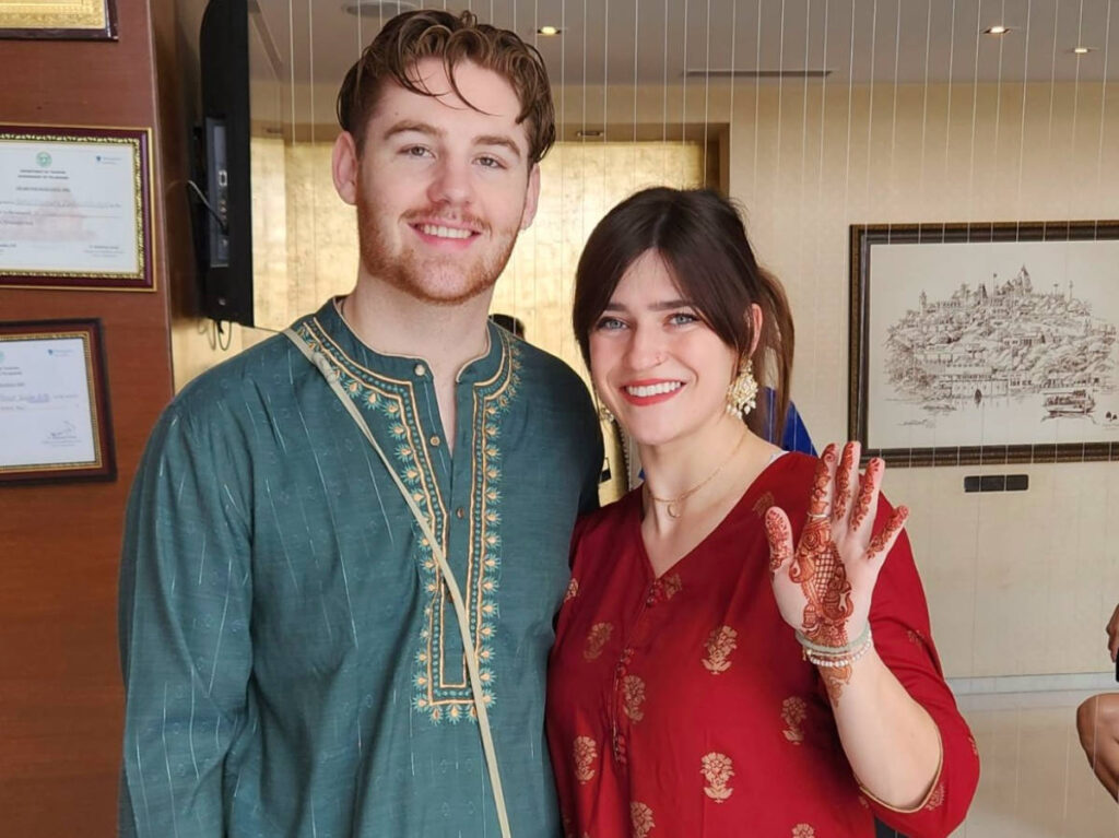 Author Betty and her boyfriend wearing saree and kurta at the wedding ceremony