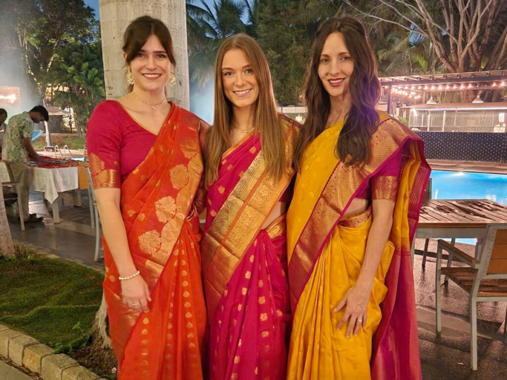 Author Betty and her cousins wearing sarees at the wedding venue