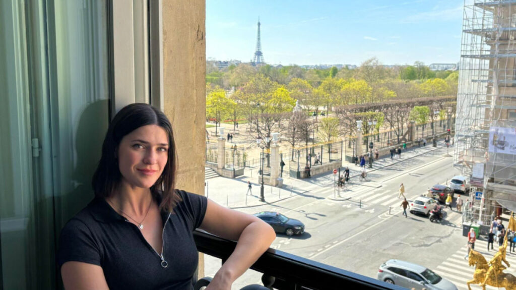 Author Betty lounging in the window of their family suite at Hotel Regina Louvre