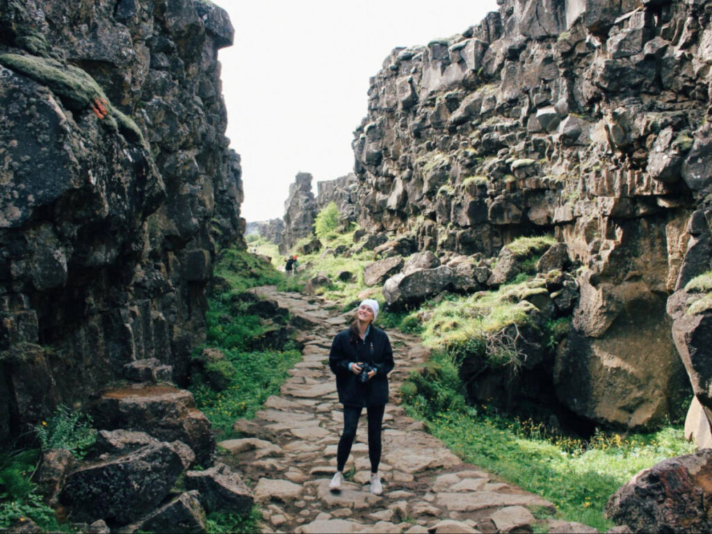 Author Betty stands on a path between rocks along the Continental Divide