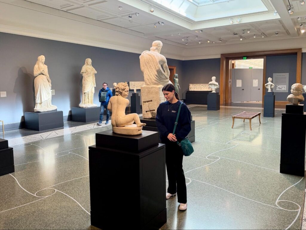 Author Betty admiring a statue at the upstairs gallery