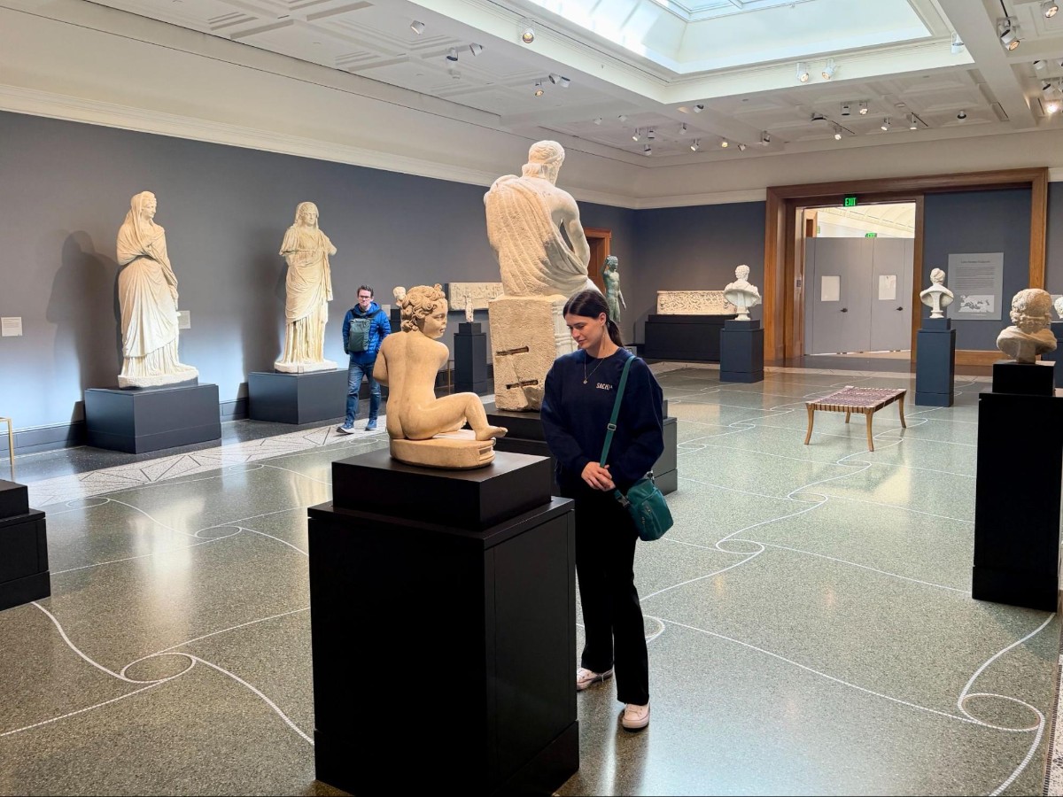 Author Betty admiring a statue at the upstairs gallery