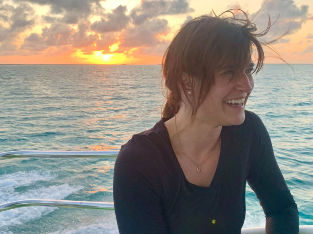 Author Betty on a boat ride during sunset