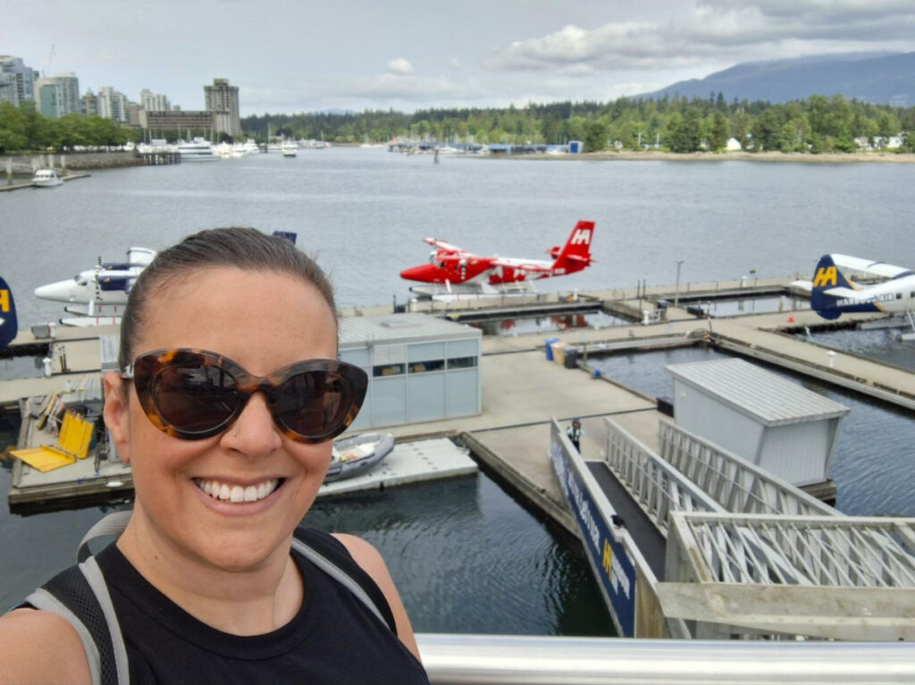 Author Catherine taking a selfie near the float planes at Vancouver’s Waterfront