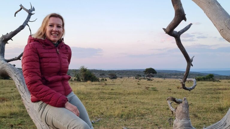 Author Elise sitting on a tree in South Africa