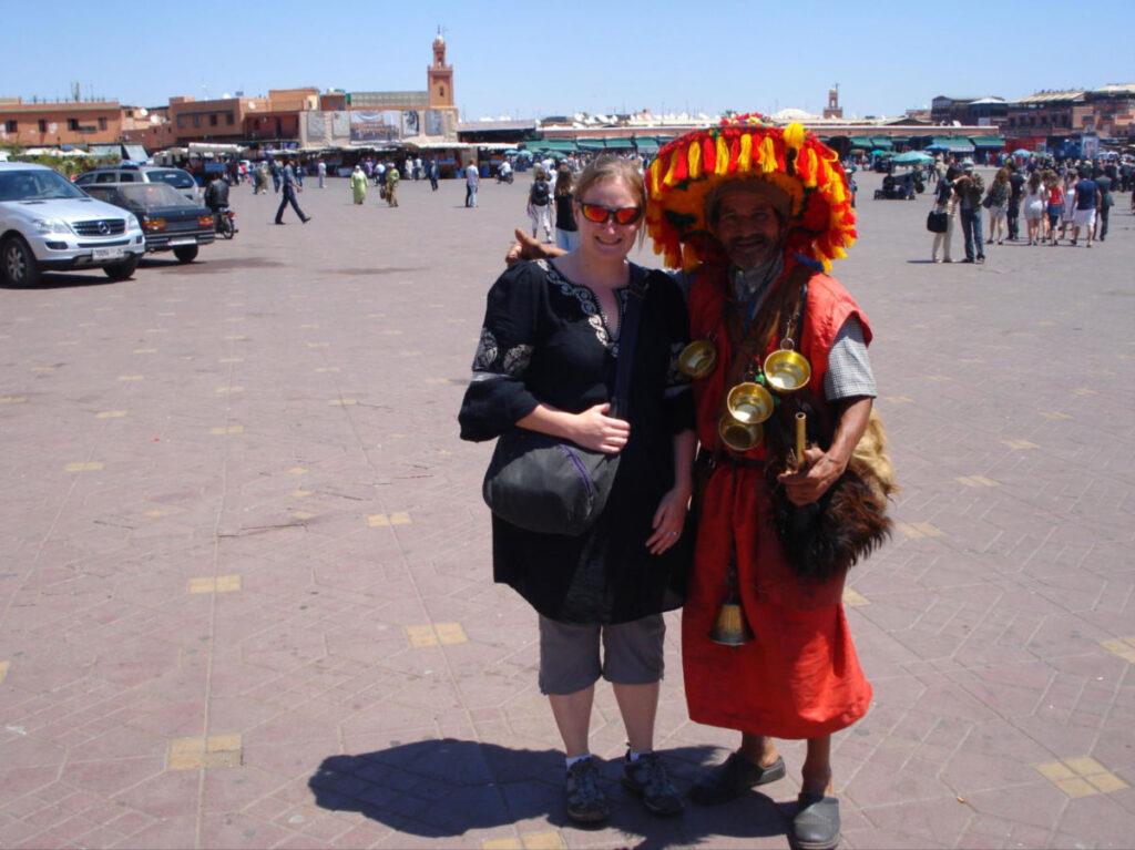 Author Heather taking a picture with one of the traditional water sellers in Djemaa el Fna