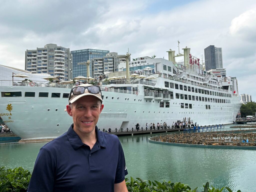 Author Ian at Sea World with the Minghua cruise ship in the background