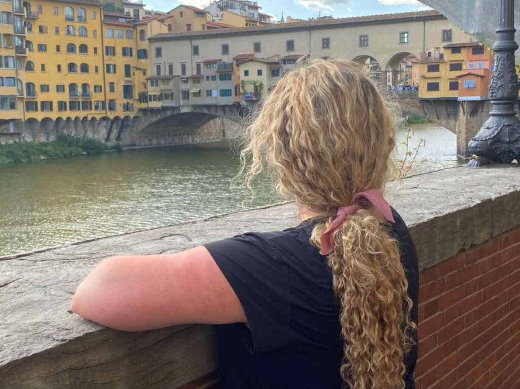Author Jess gazing at the Ponte Vecchio Bridge in Florence