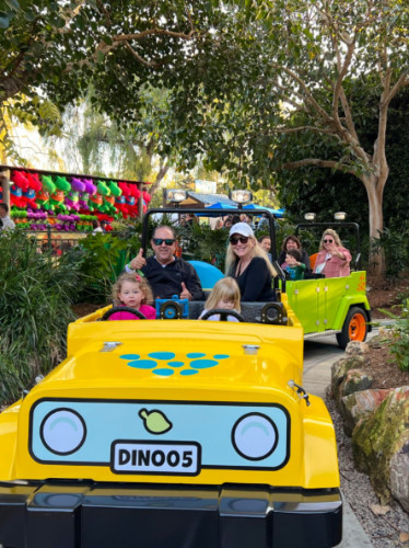 Author Jess and her family on a ride at Dino Valley