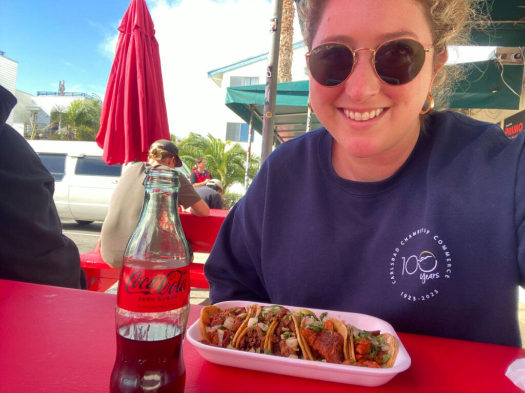 Author Jess with a bottle of coke and tacos at Primo Market